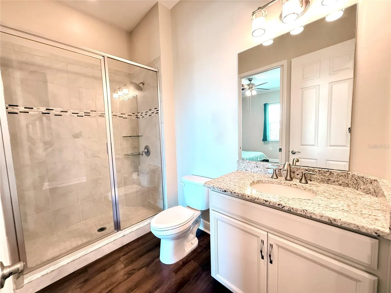 en-suite bathroom with granite countertops