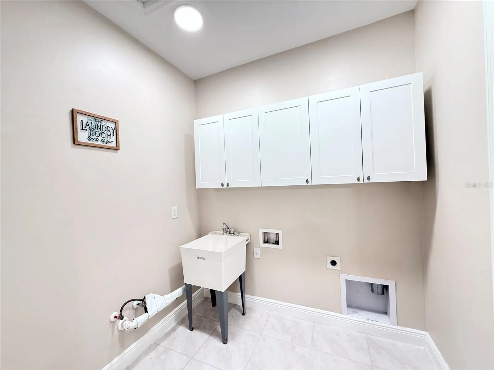 Laundry room with utility sink and cabinets!