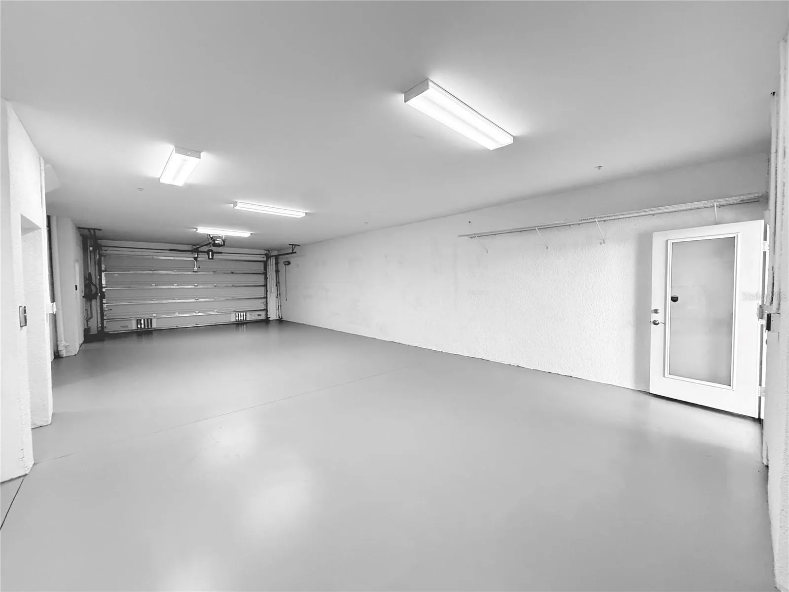 4 car garage with workshop space!! Rear screened patio just off of it!
