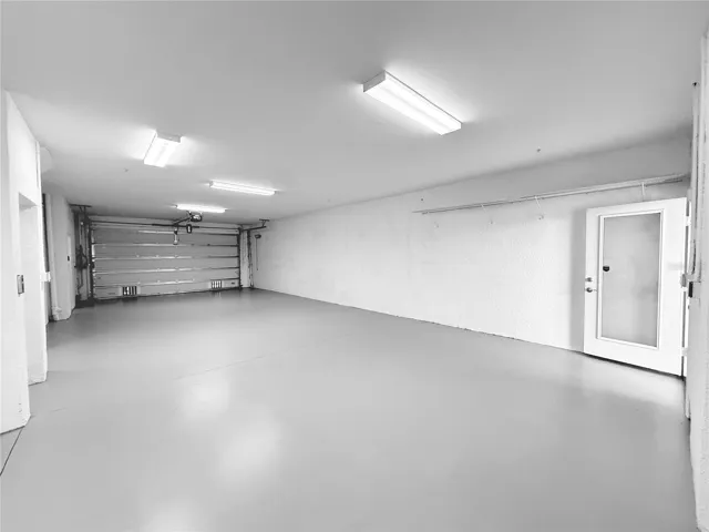 4 car garage with workshop space!! Rear screened patio just off of it!