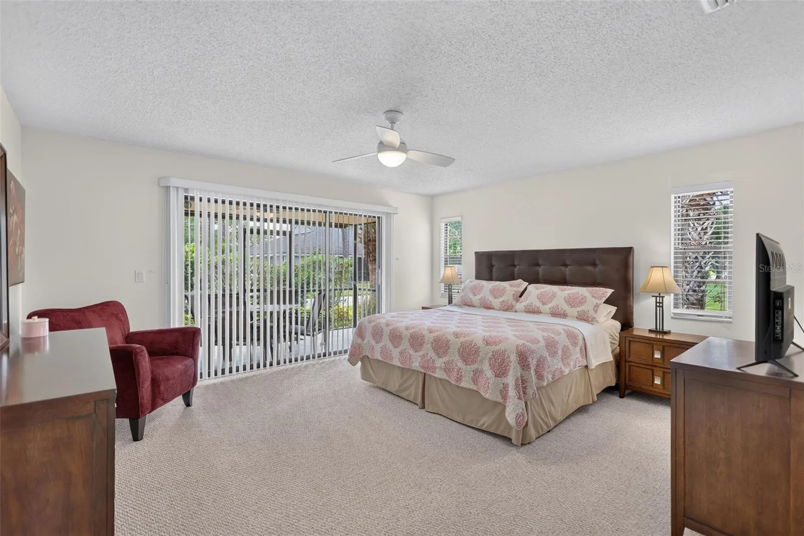 Master Bedroom is carpeted and features sliding doors to the lanai