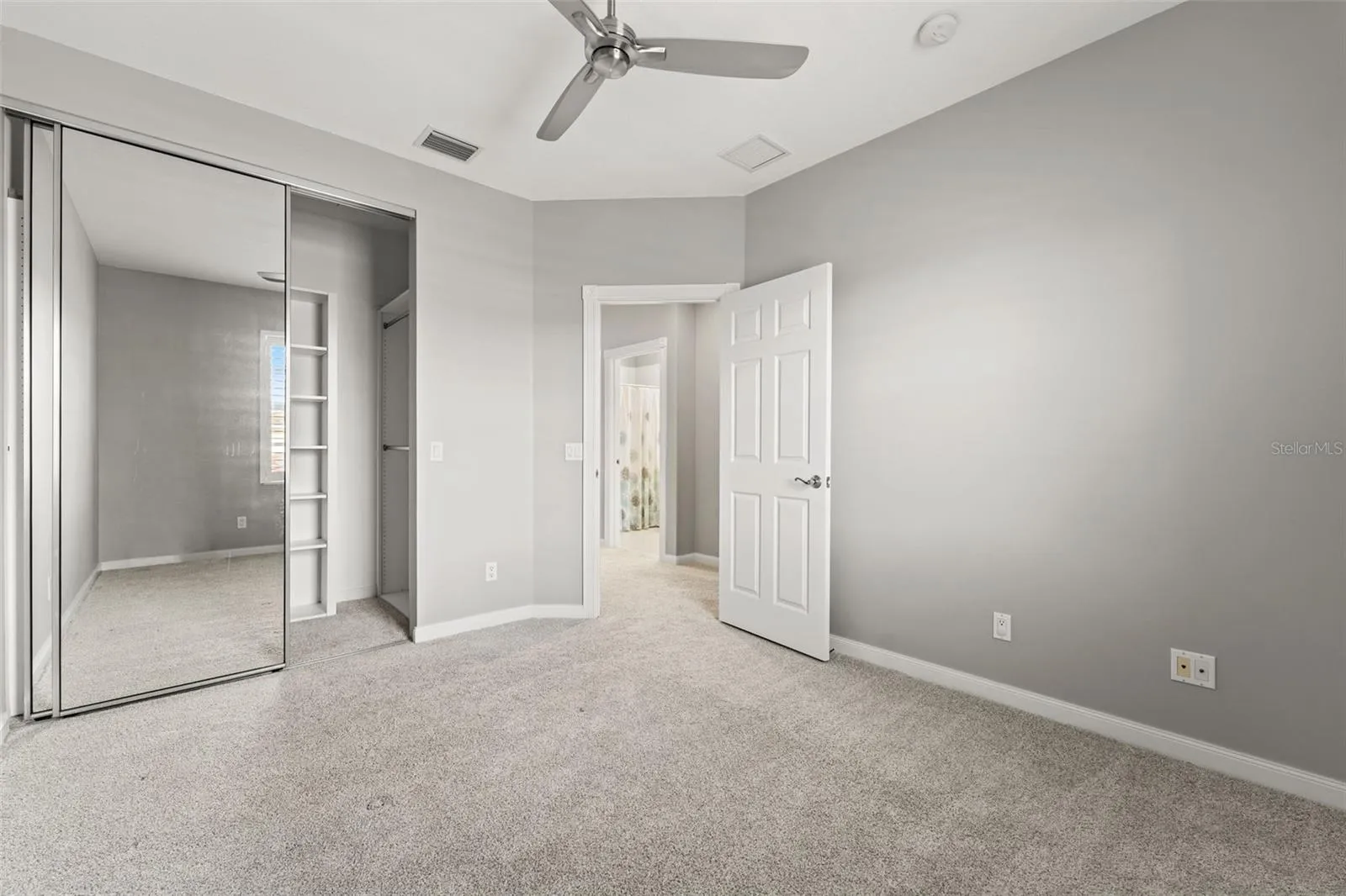 Third bedroom with a walk in closet