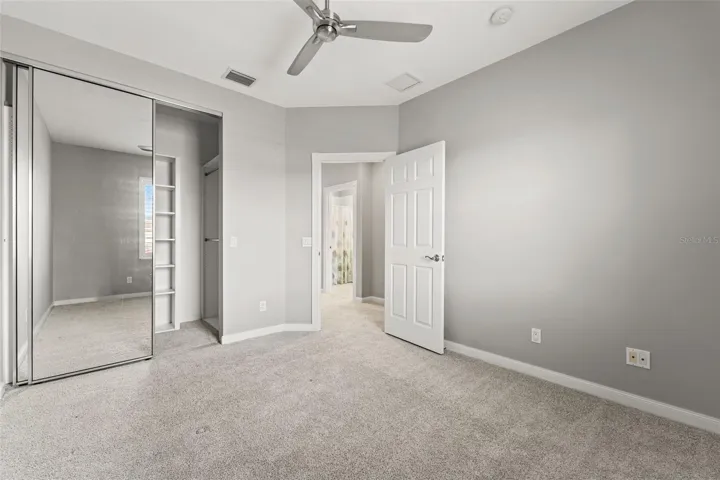 Third bedroom with a walk in closet