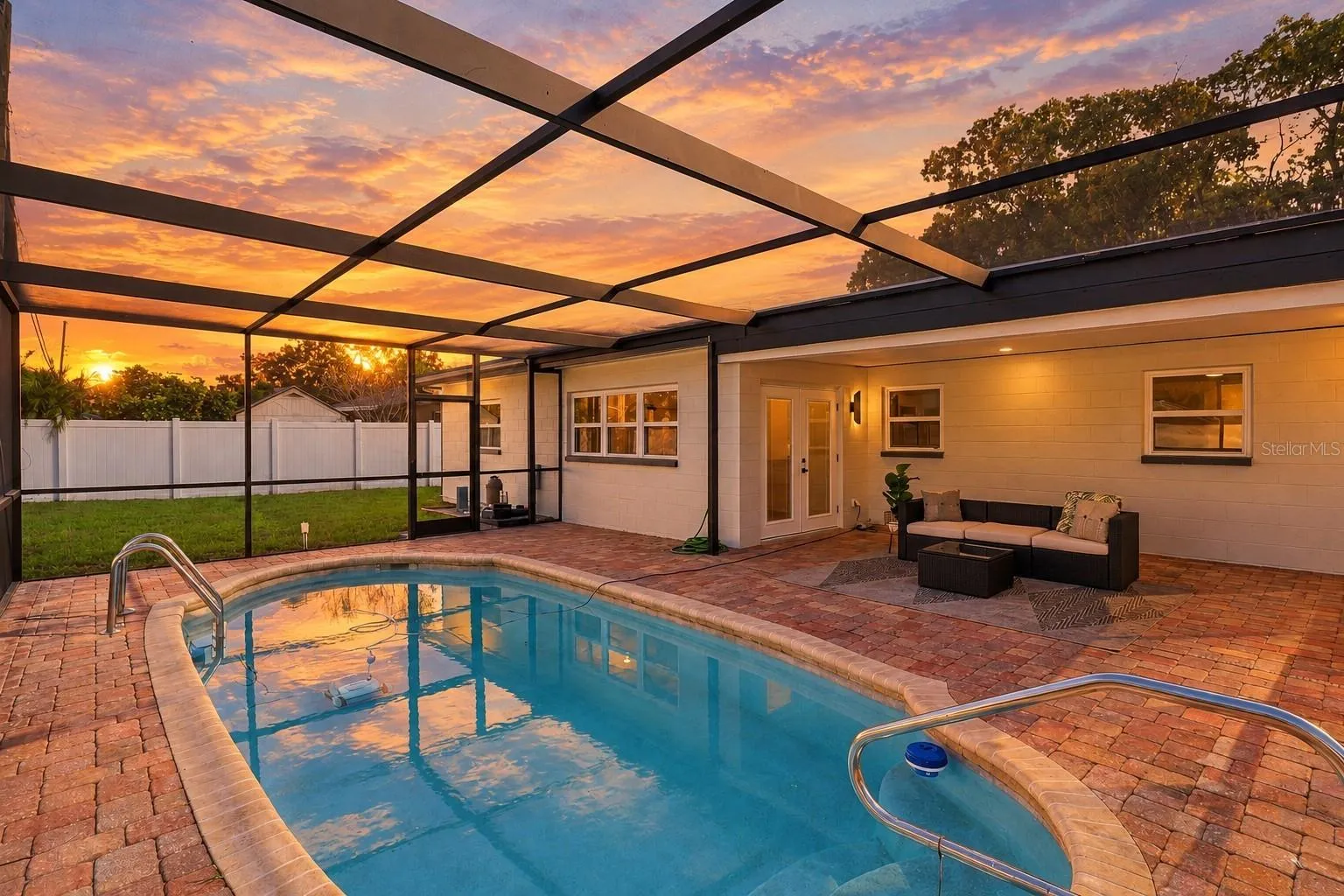 Enjoy beautiful Florida sunsets from your private screened-in pool and spacious paver patio, the perfect setting for relaxing, entertaining, and enjoying outdoor living year-round.