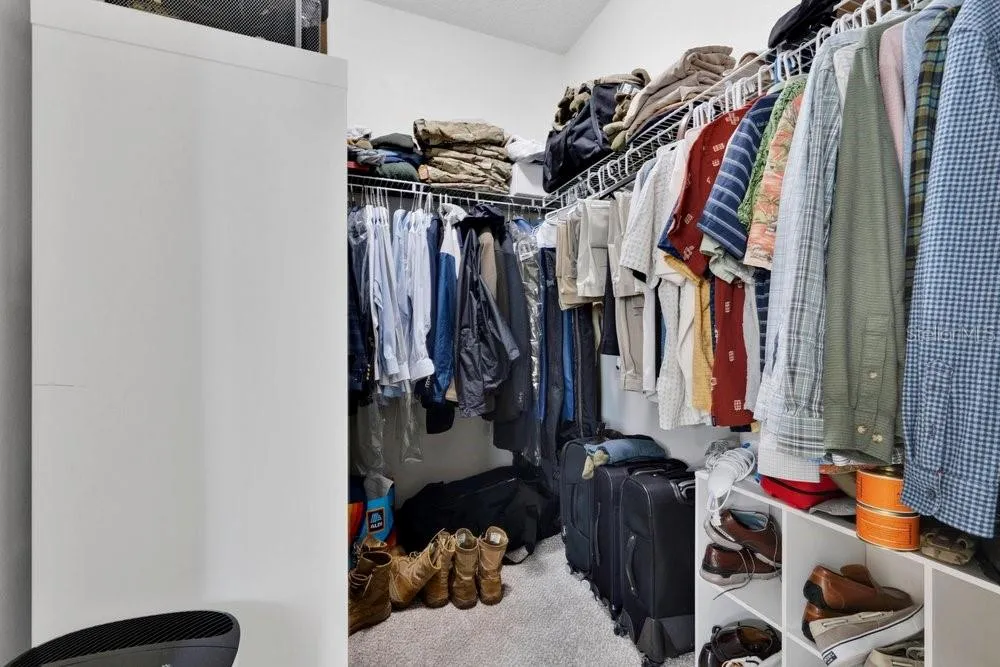 Primary bedroom walk-in closet 1 of 2