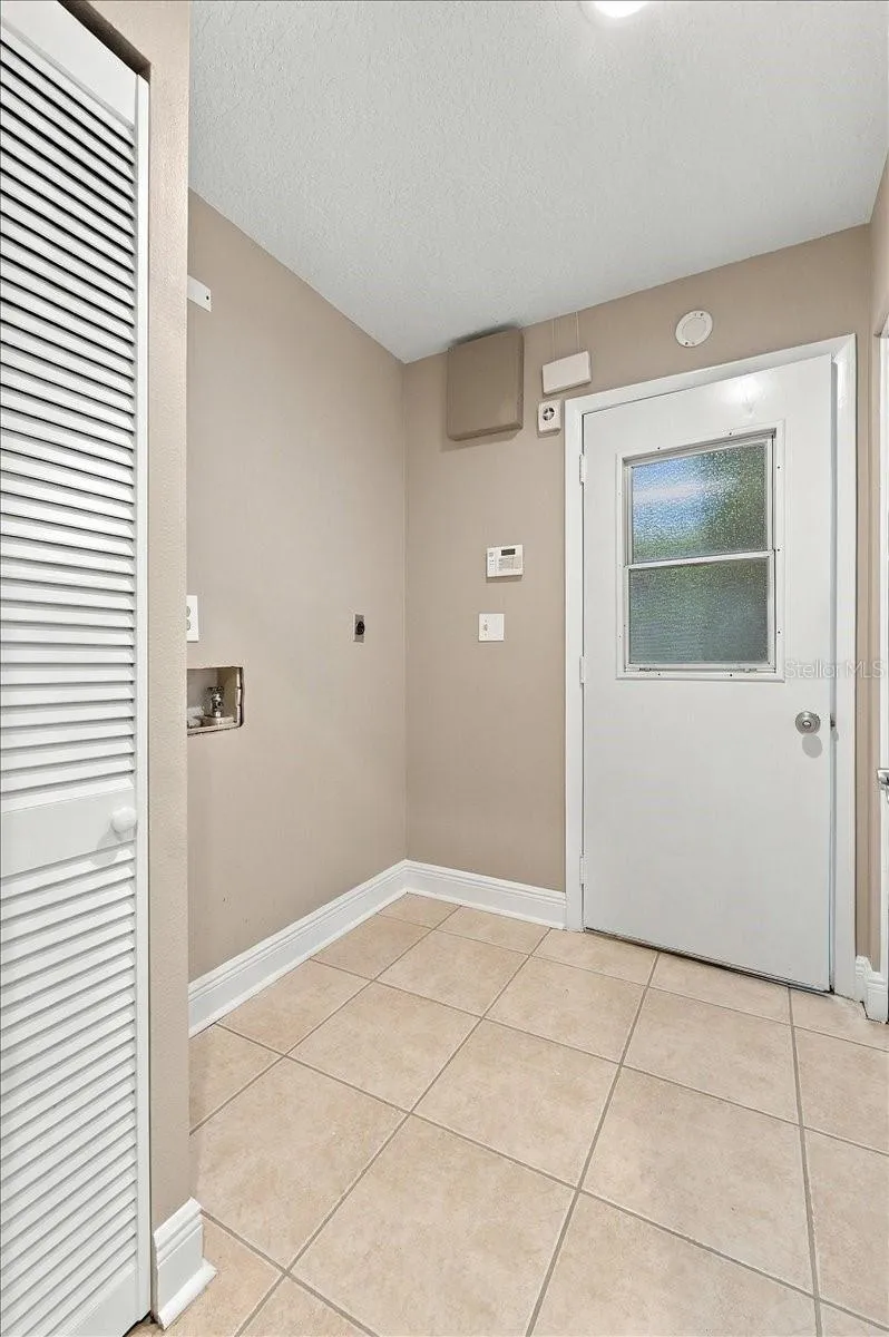 Inside utility room with access to the garage. Electric washer and dryer hook ups.