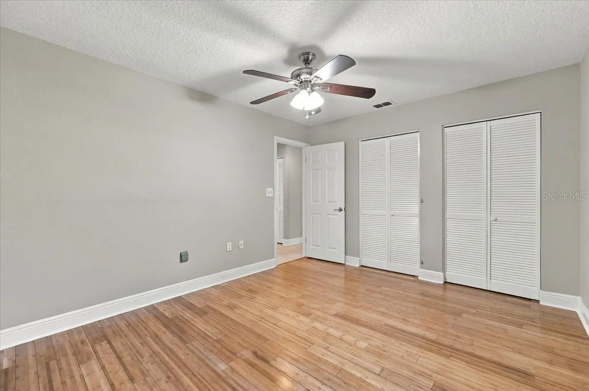 2nd bedroom with double closets, ceiling fan, new blinds and bamboo hardwood flooring.