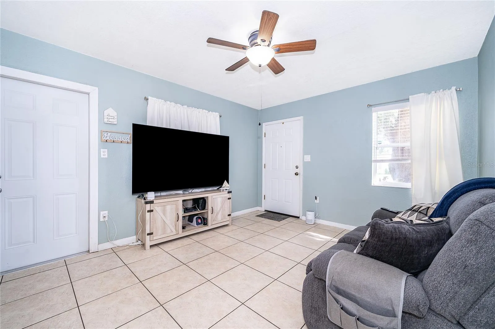 Make yourself at home in this comfortable living room, offering natural light and plenty of space to gather with family and friends.