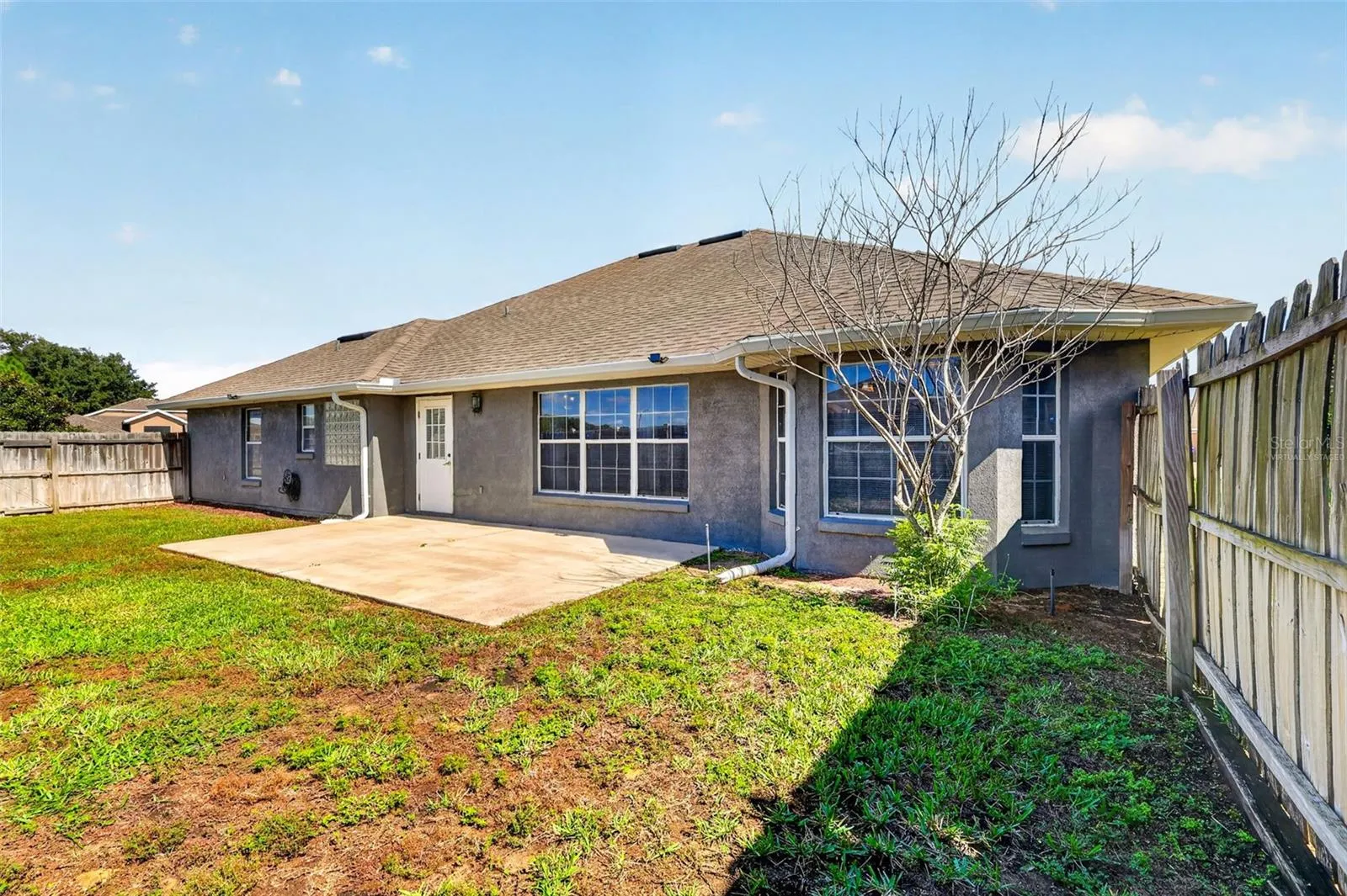 *virtually staged* Patio with fenced backyard