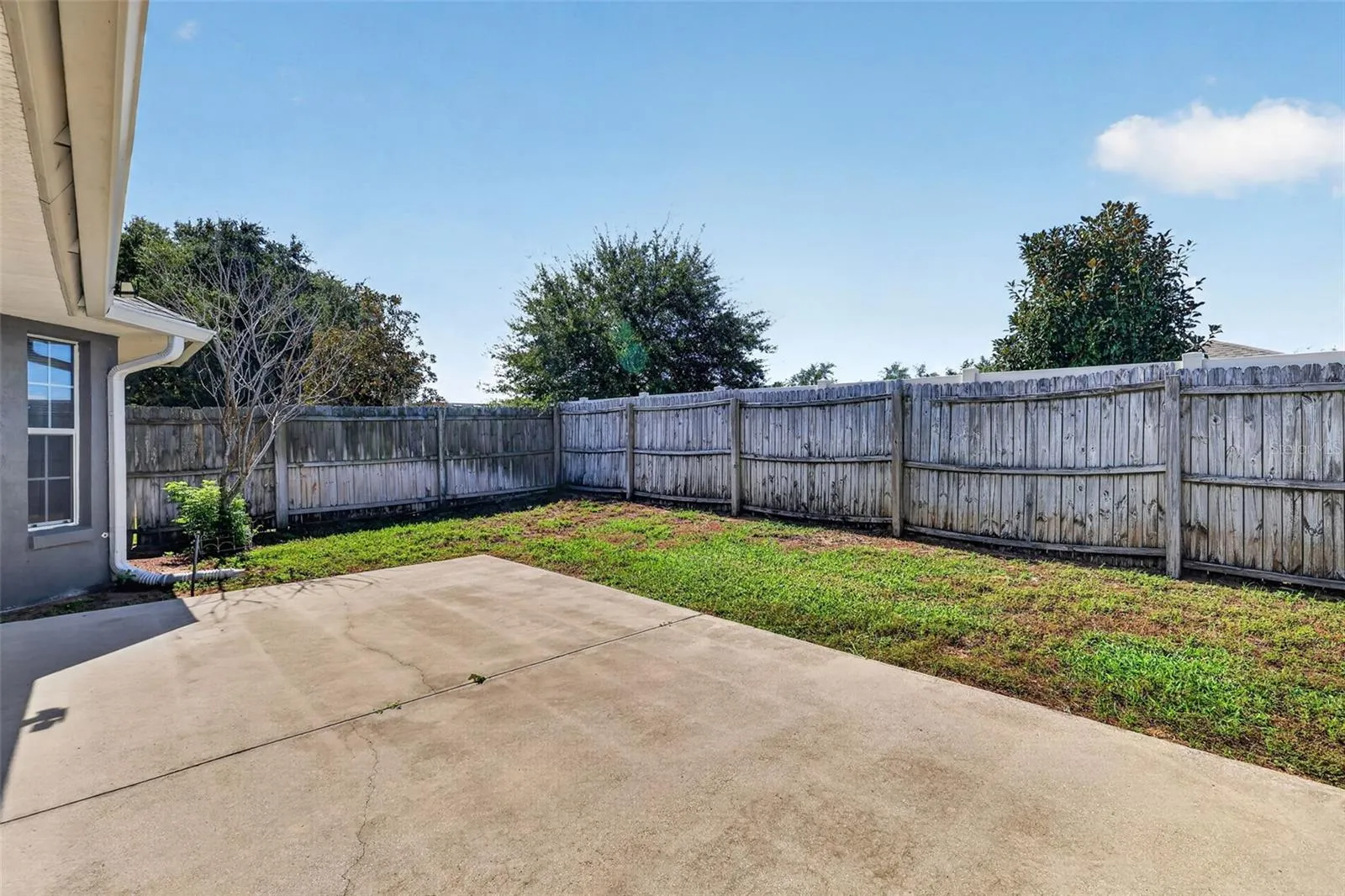 Patio with fenced backyard