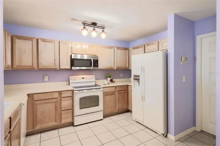 The kitchen features maple wood cabinetry, an updated microwave