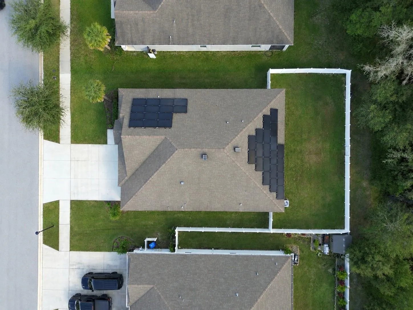 Lot overhead view, includes fully fenced backyard and solar panels