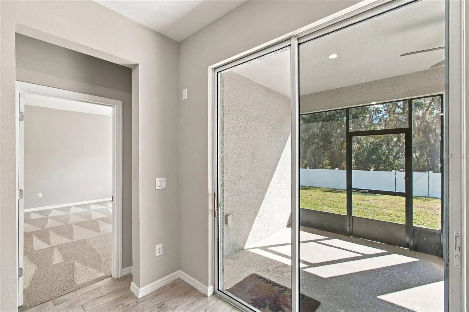 Primary Suite entrance to left, screened in patio to right