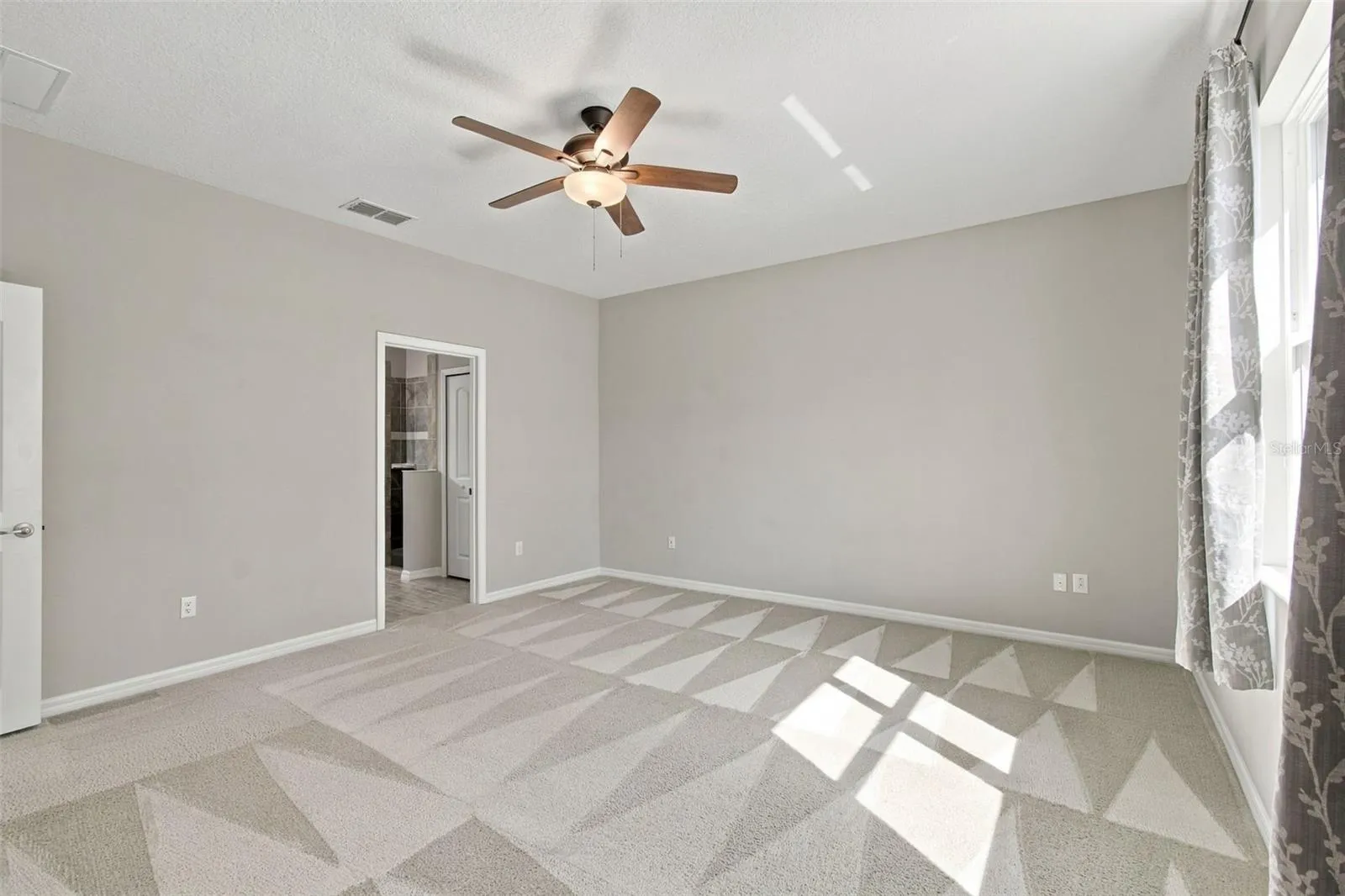 Primary bedroom with ceiling fan