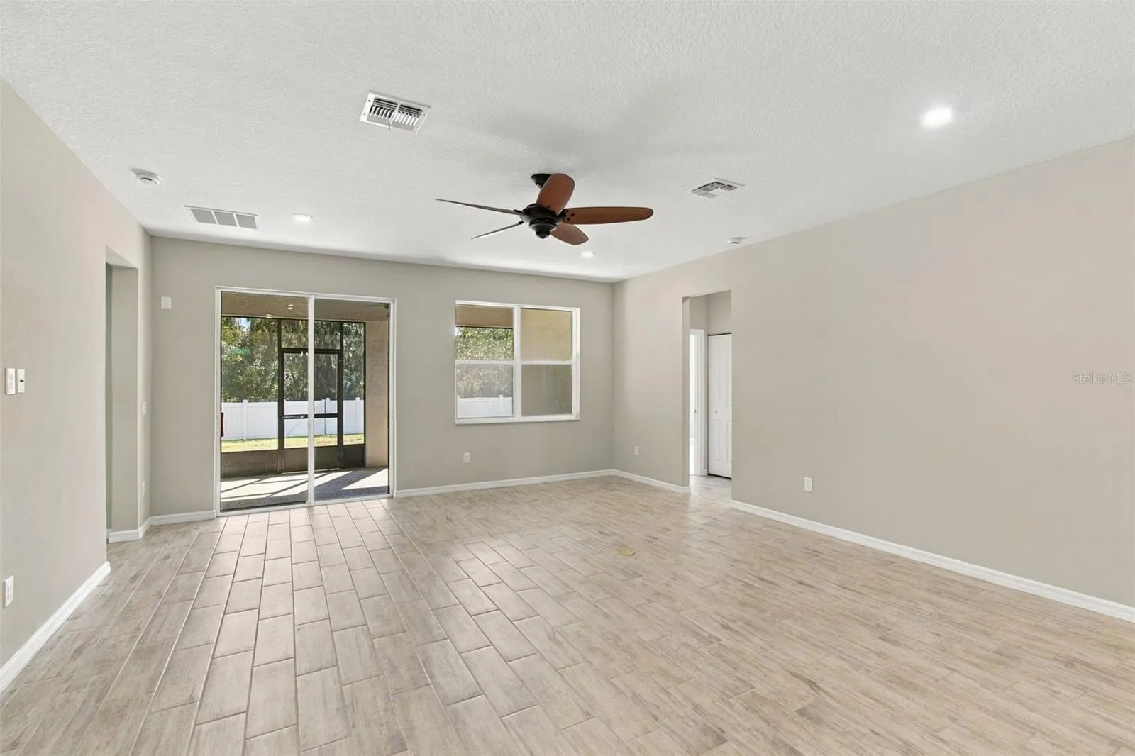 Return to Living Room, facing patio and backyard, heading towards Bedrooms to the right