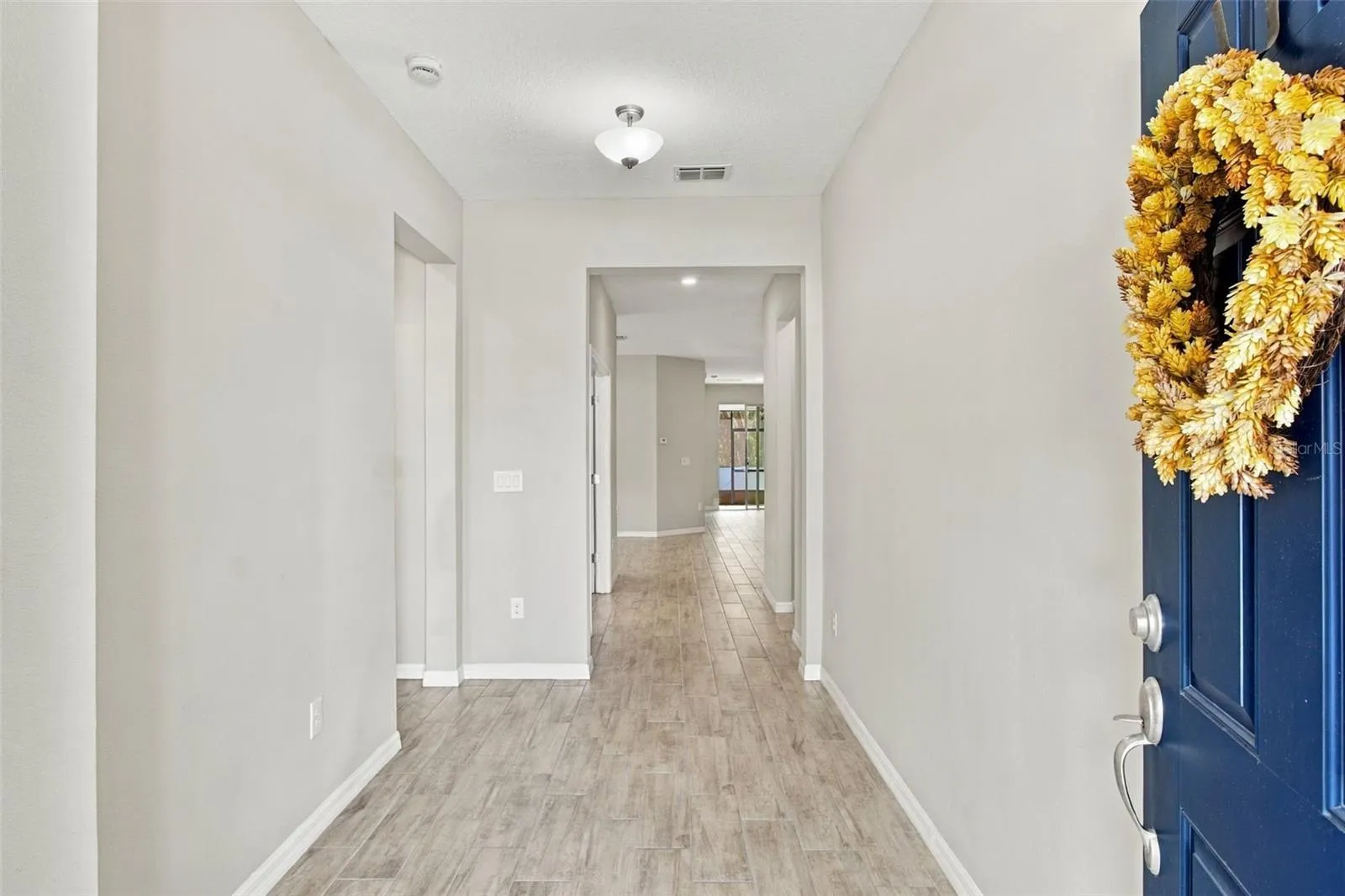 Foyer (guest suite entry to your left, followed by the office) - view extends to living room and patio in background