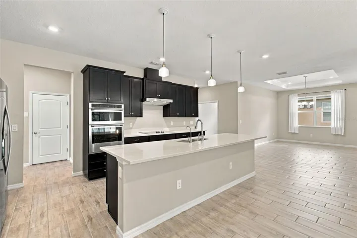Plenty of room for counter stool seating - garage door in background to the left, dining roo to the right