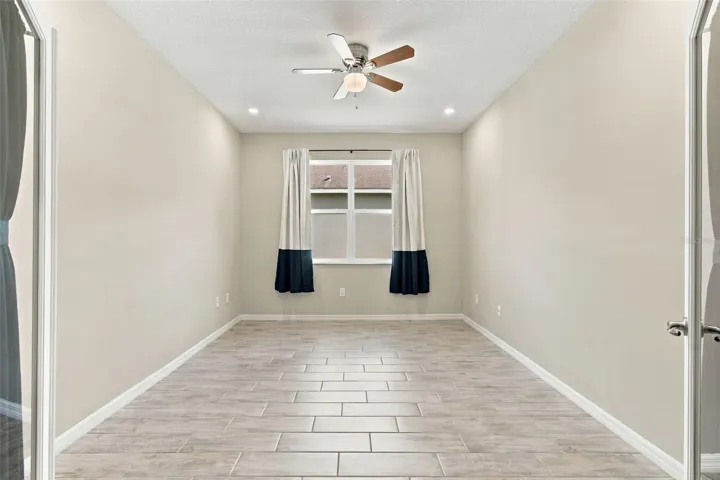 French doors open to private office with ceiling fan