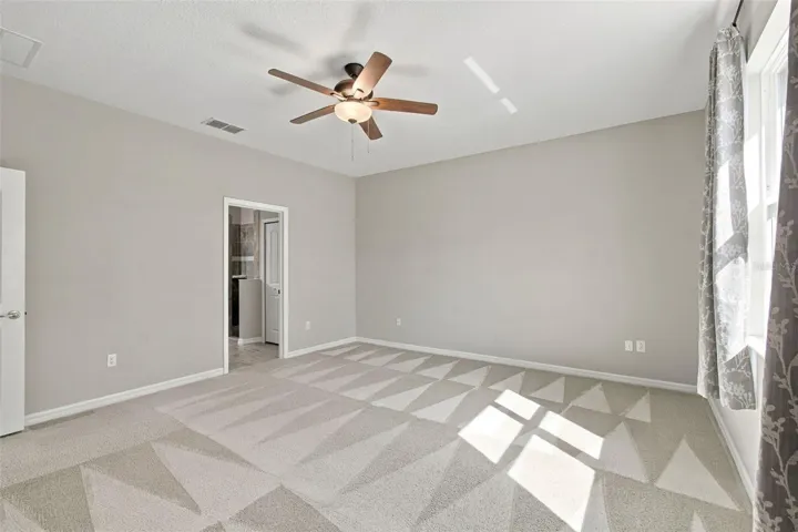 Primary bedroom with ceiling fan