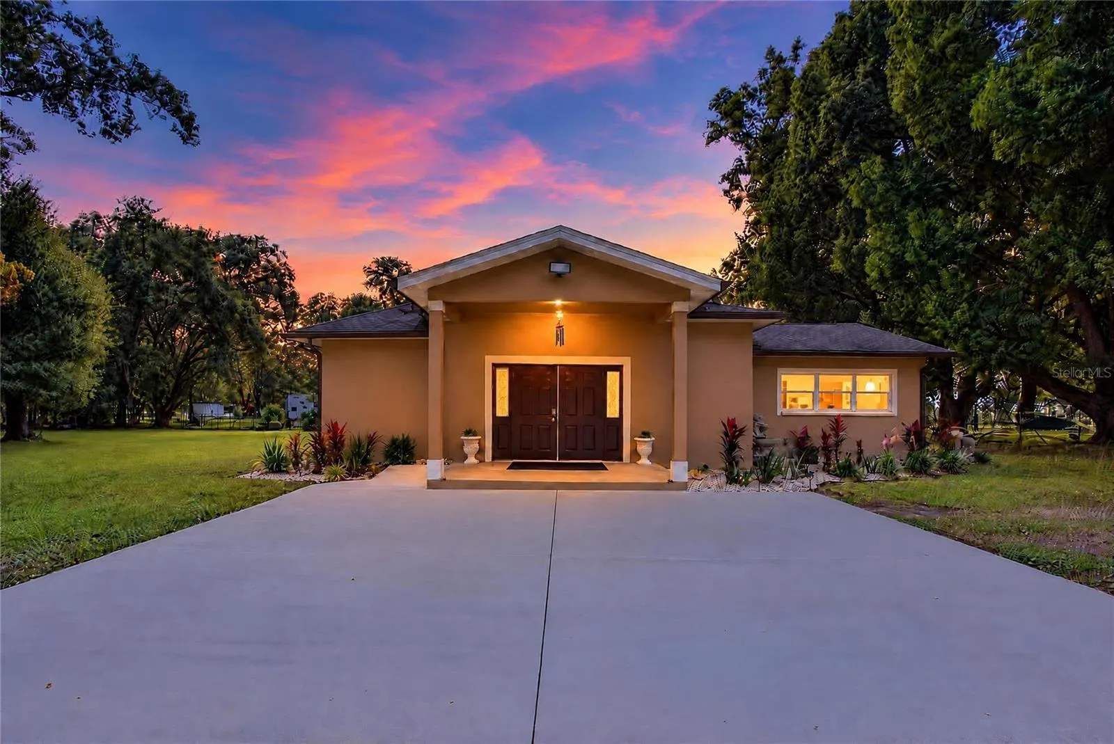 This photo has been digitally modified to illustrate how the front of the home would look without the existing carport.