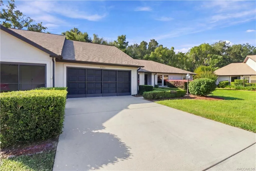 PULL RIGHT IN! Spacious CONCRETE DRIVEWAY leads to the attached 2-CAR GARAGE, surrounded by lush green lawn &amp; attractive landscaping!