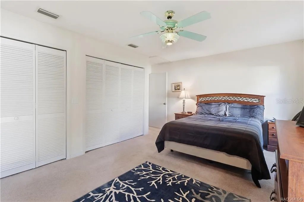 ROOM TO RELAX! PRIMARY SUITE features GENEROUS CLOSET SPACE w/multiple louvered closet doors, soft neutral carpeting &amp; ceiling fan!