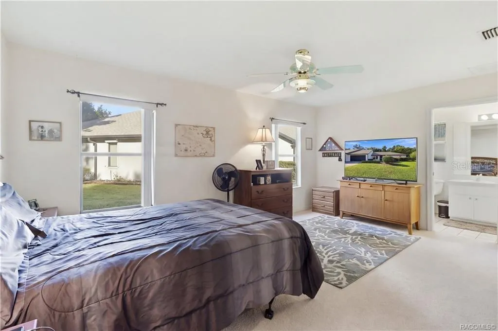 YOUR OWN PRIVATE RETREAT! Spacious PRIMARY BEDROOM offers comfortable surroundings, TWO WINDOWS, CEILING FAN &amp; convenient access to the EN-SUITE BATH!