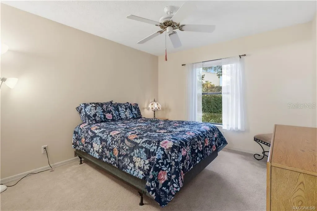 SWEET DREAMS! Comfortable GUEST BEDROOM offers neutral carpeting, CEILING FAN &amp; a window overlooking the attractive outdoor greenery!