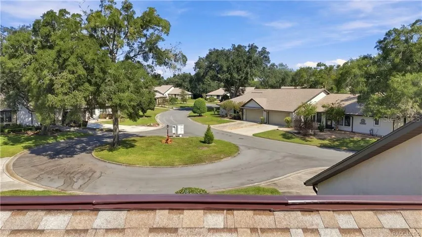 COMMUNITY CUL-DE-SAC VIEWA bird's-eye view of the neighborhood's peaceful cul-de-sac setting, surrounded by mature shade trees, landscaped lawns, and neighboring residences.