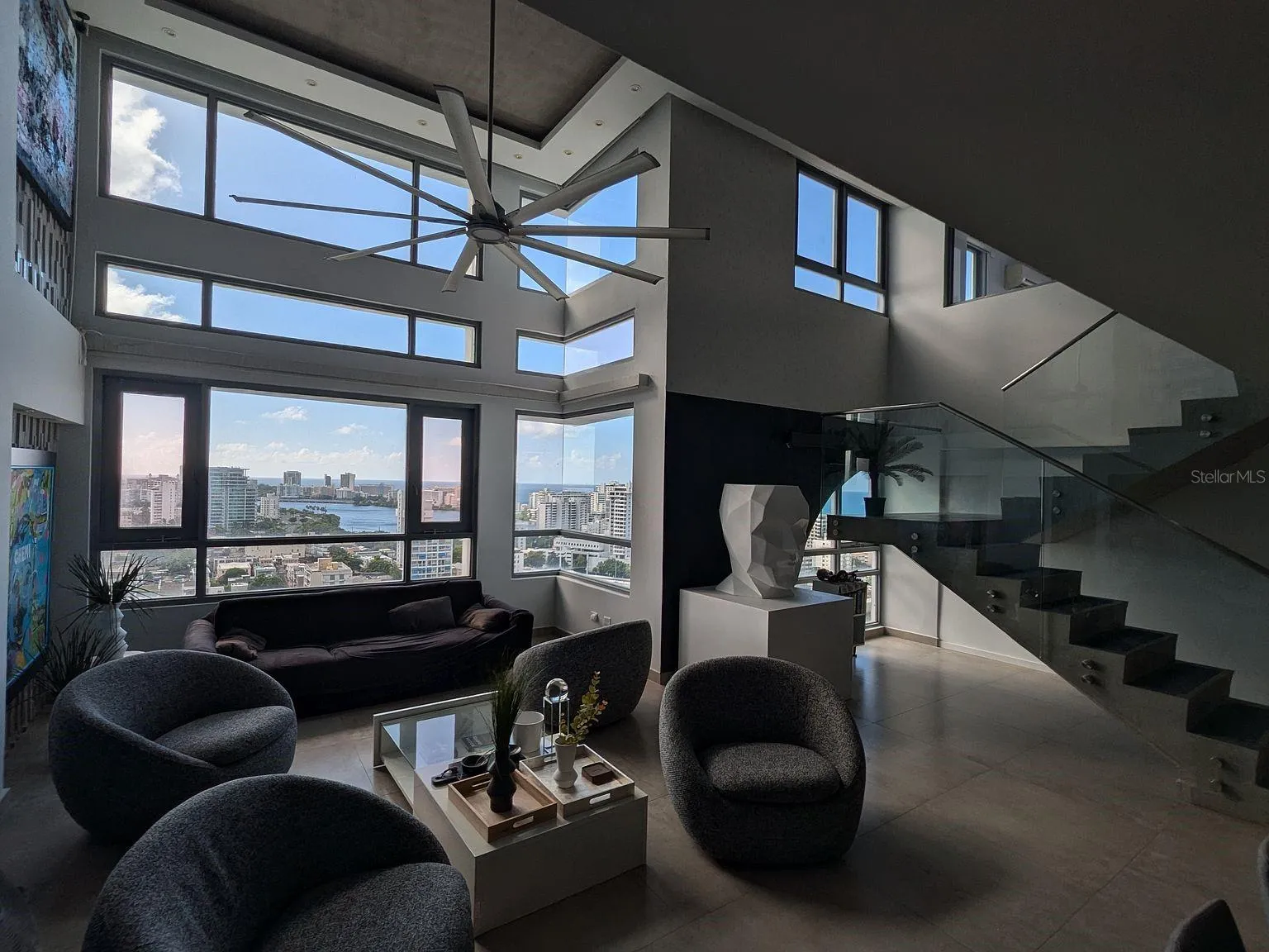 Living room – double-height windows with lagoon and ocean views Living room – double-height windows with lagoon and ocean views