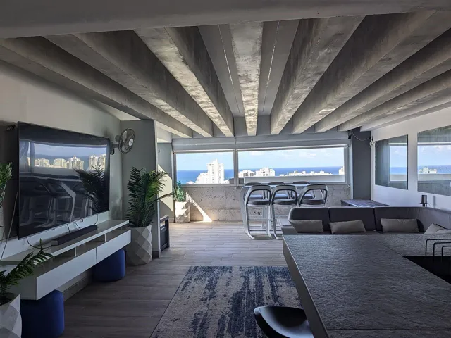 Covered terrace lounge – exposed beams and ocean views