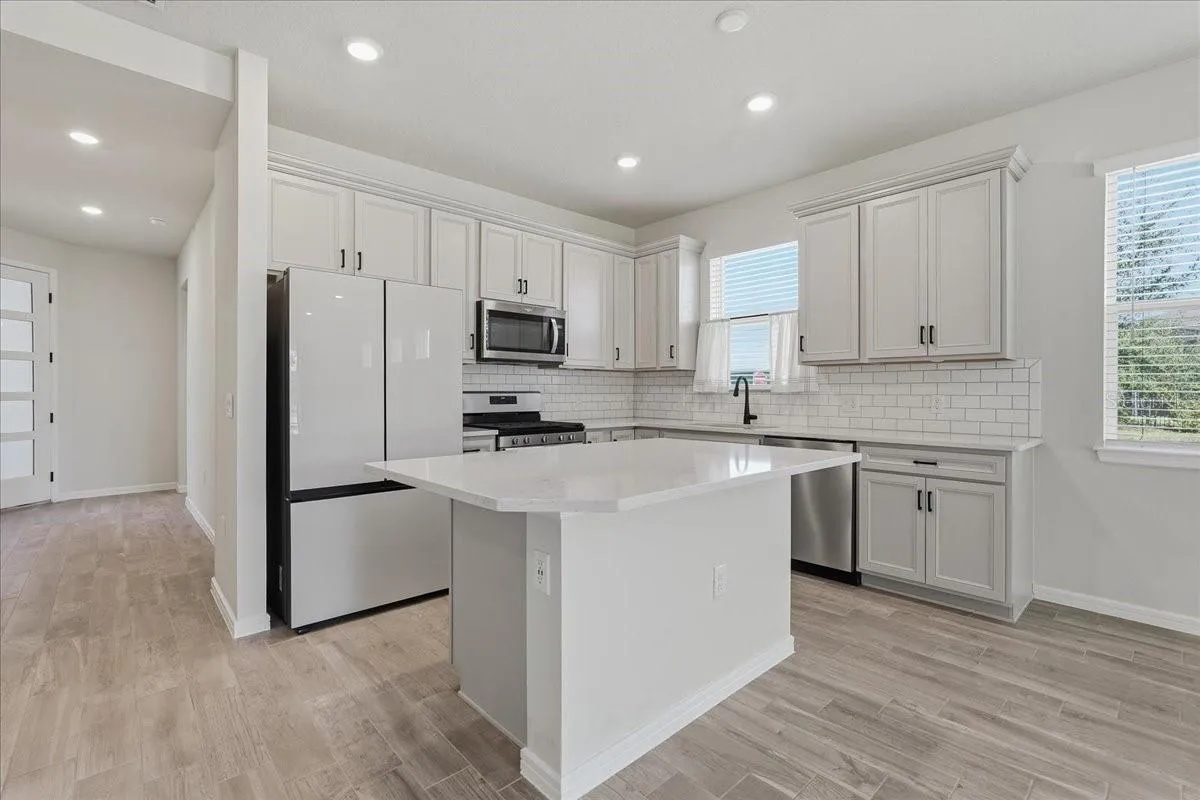 Kitchen with Quartz Countertops and Subway Tile Backsplash