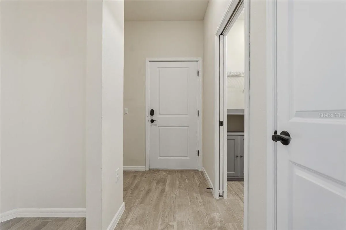 Garage Door Entry - Laundry Room on right with pocket door