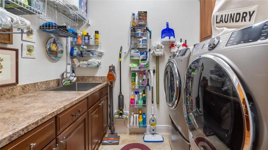 Laundry Room with Cabinetry and Sink