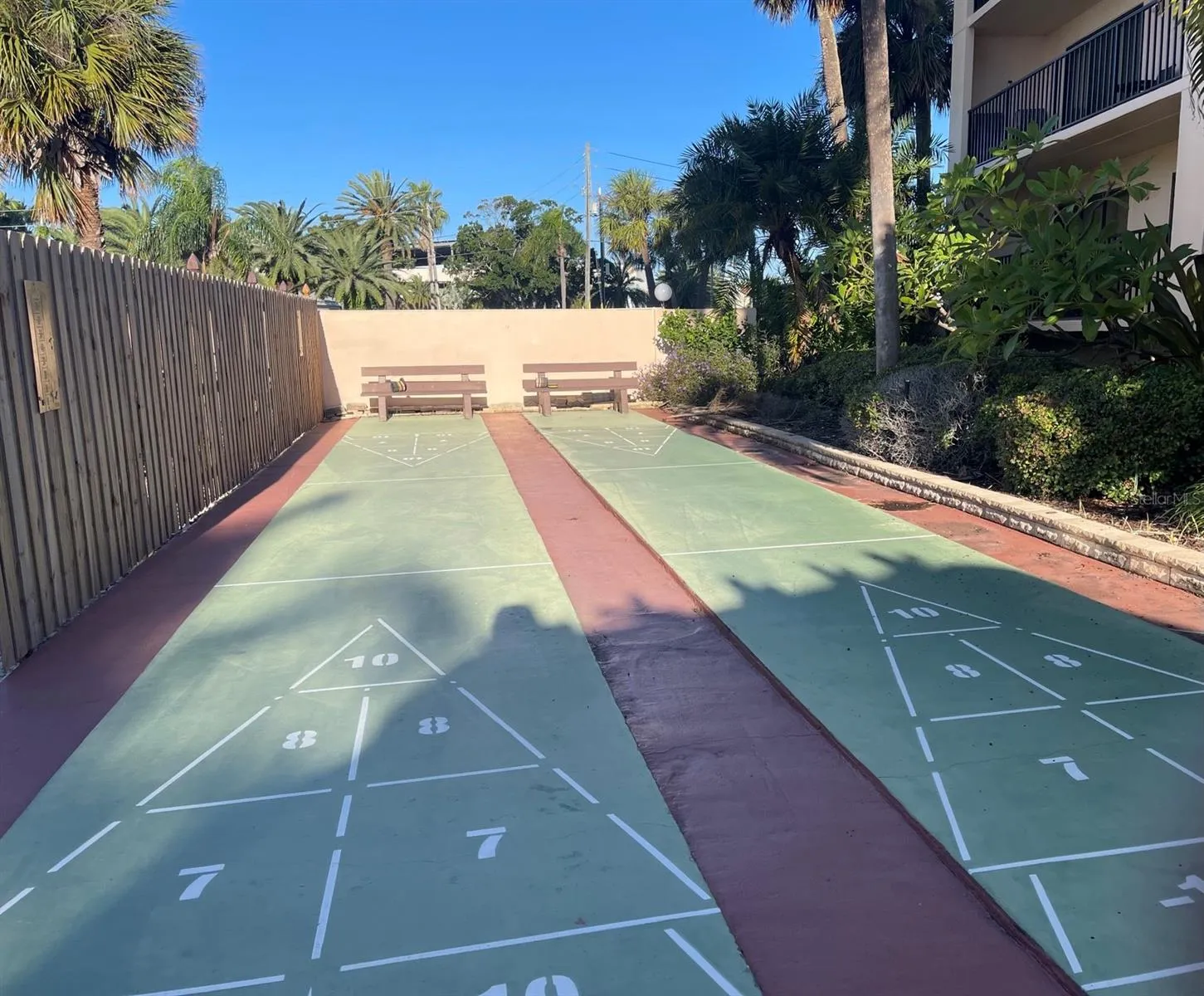 Two private shuffleboard courts south end of the building