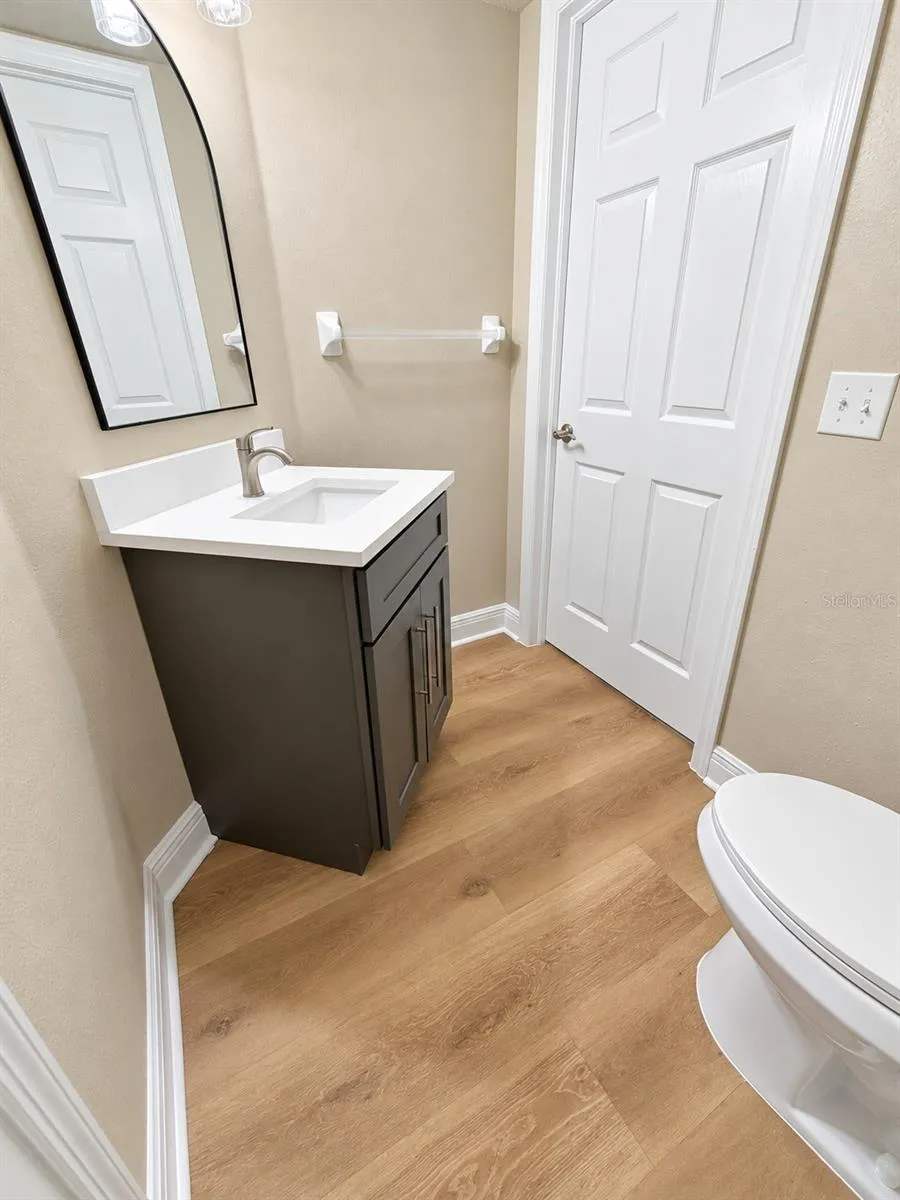 Half Bathroom - New Cabinetry, Stone Countertop and Fixtures