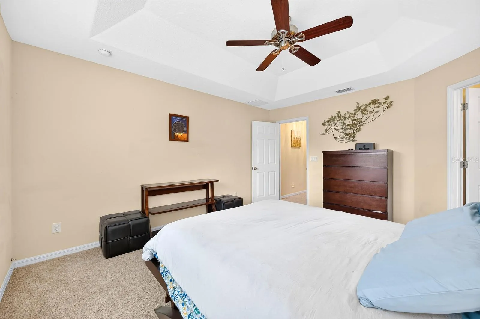 Upstairs, the spacious Primary Bedroom offers a TRAY CEILING, plush carpet and a private EN SUITE BATH.