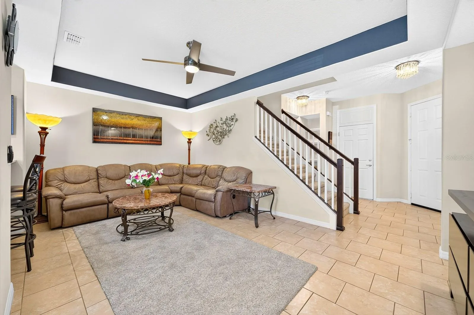 The Living Room features an ELEGANT TRAY CEILING and modern ceiling fan.