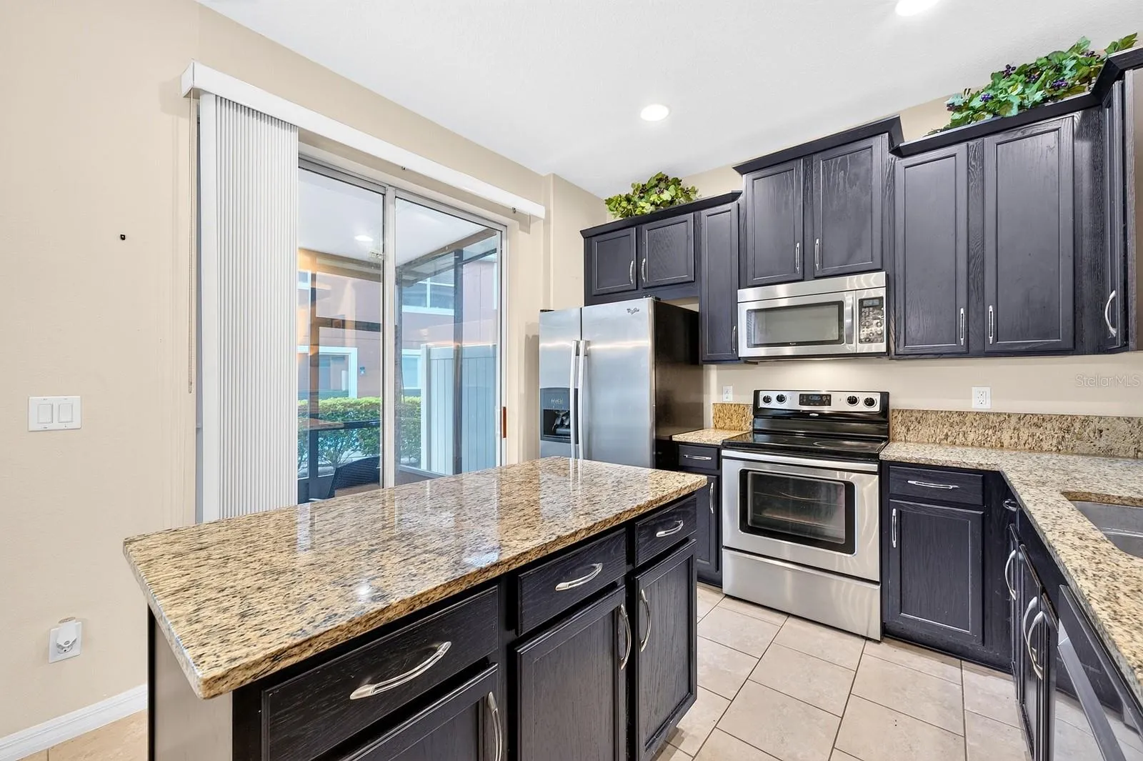 Sliding glass doors in the Kitchen, extend the living space outdoors.