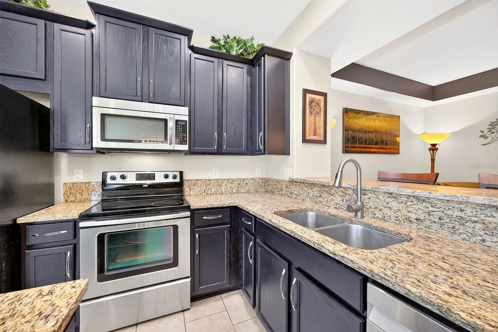 A generous breakfast bar doubles as a comfortable spot for quick meals or gathering with guests.