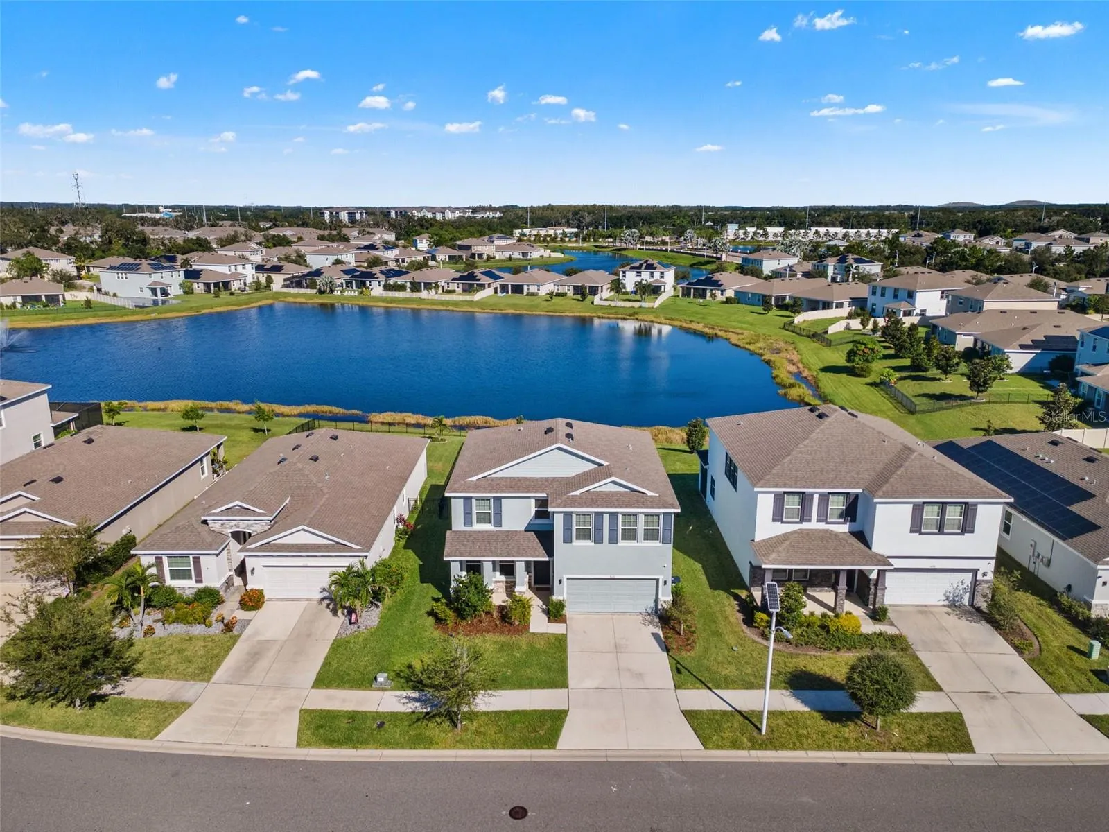 Front aerial with pond backdrop - 5126 Jackel Chase Dr, Wimauma