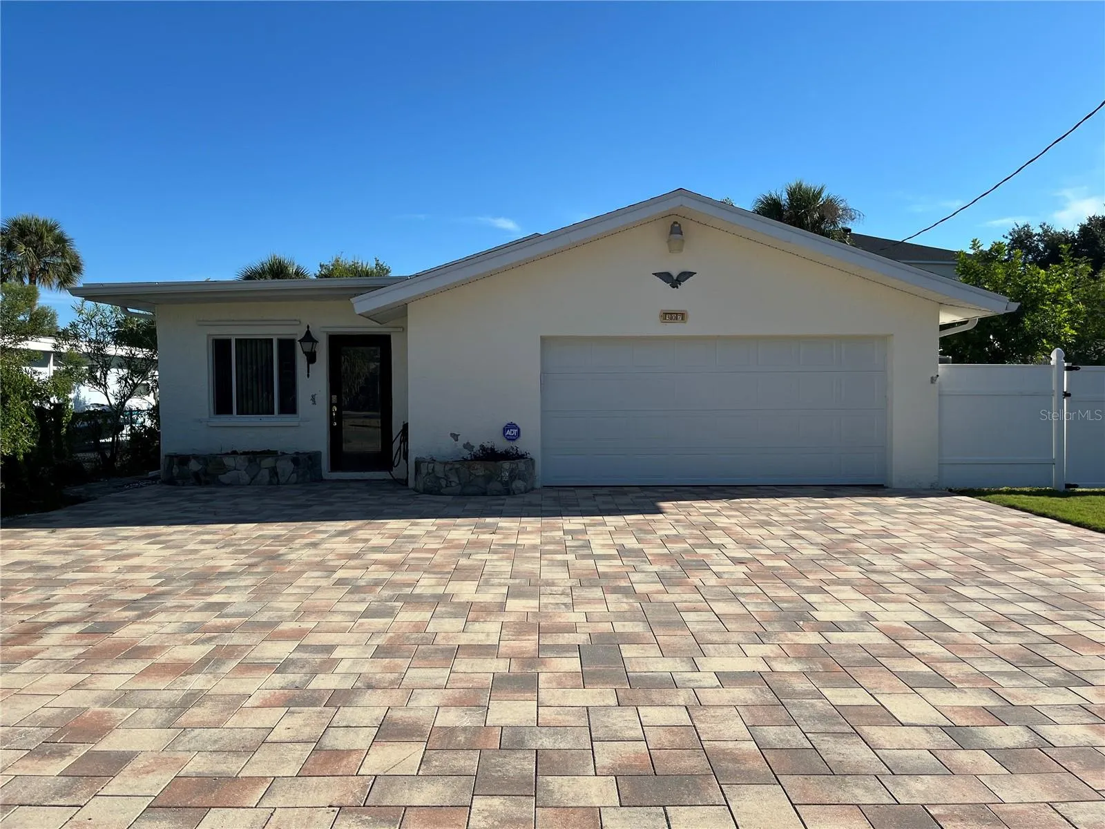 Front exterior of the home with plenty of paved parking