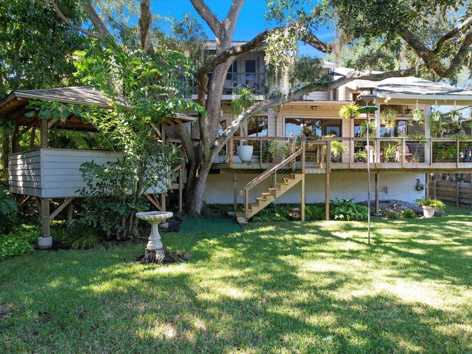 Access to the porch and Gazebo to the left nestled among the trees