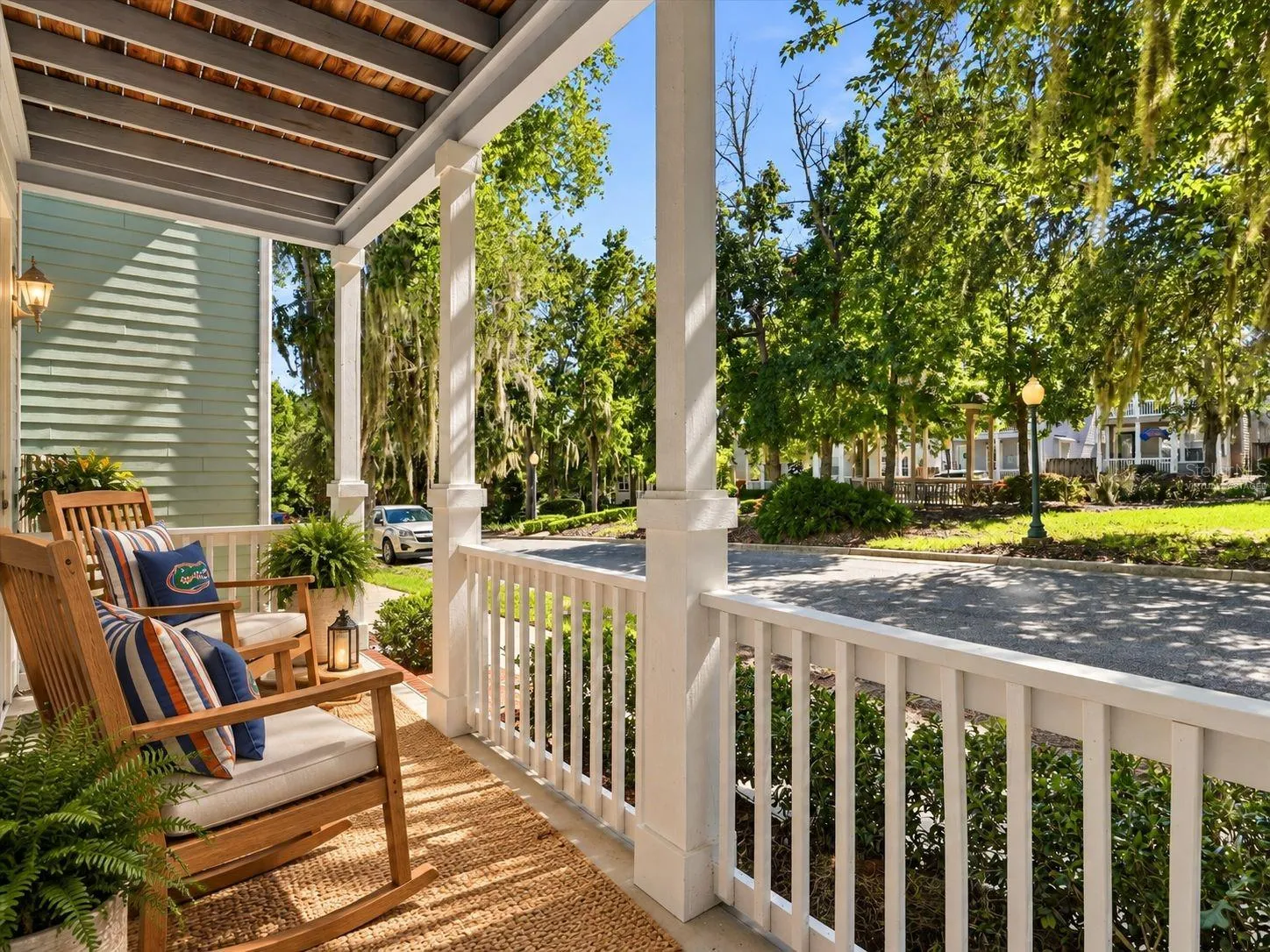 Virtually Staged - Front Porch with rocking chairs under a shade tree.
