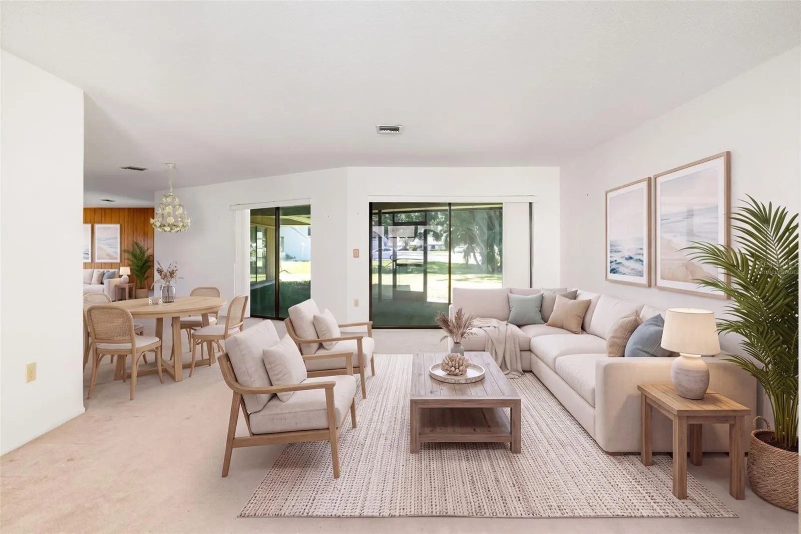Virtually Staged. Spacious living and dining area with sliders to the screened lanai.