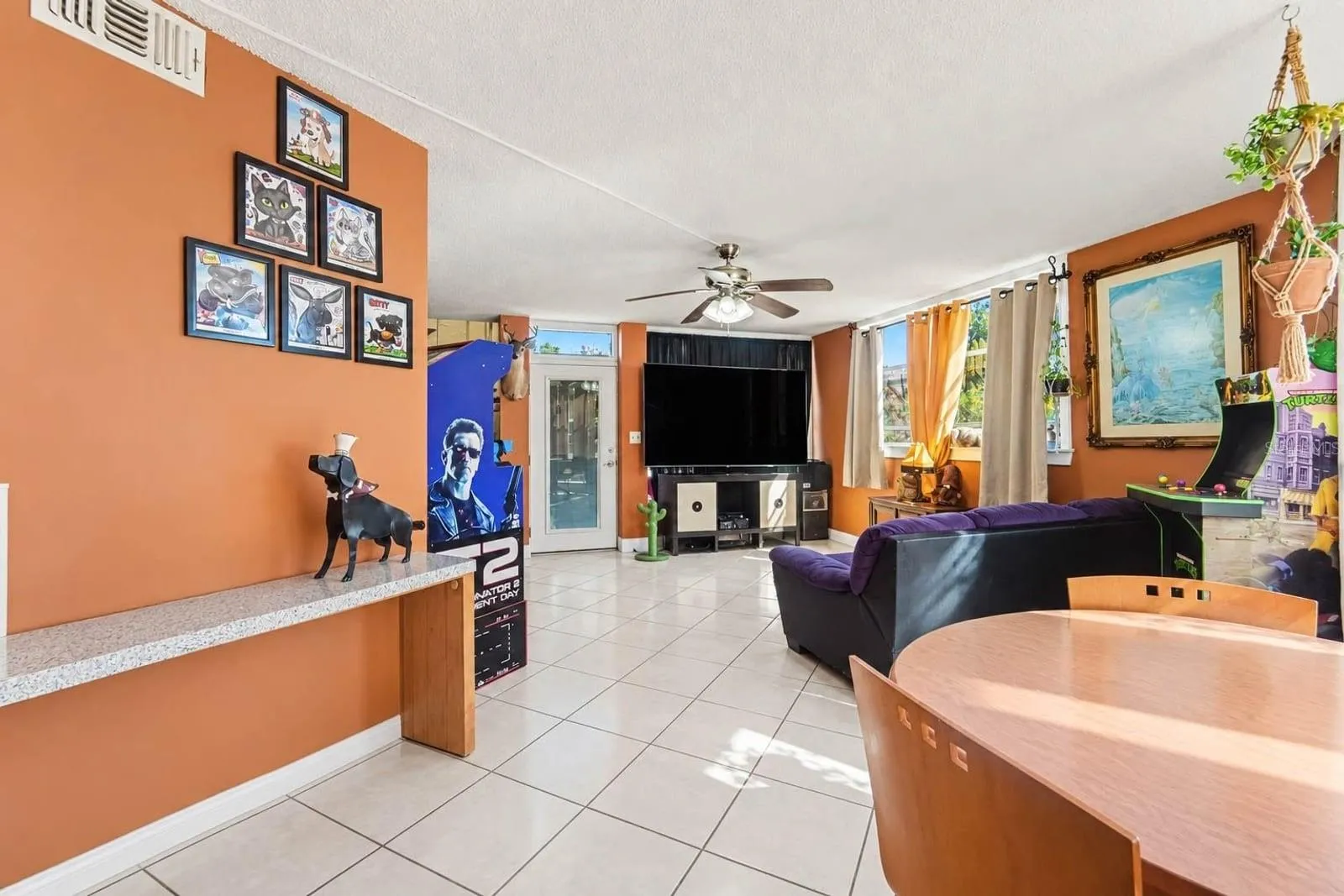 Game Room &amp; Living Area with Orange Walls, Built-in Features &amp; Bar