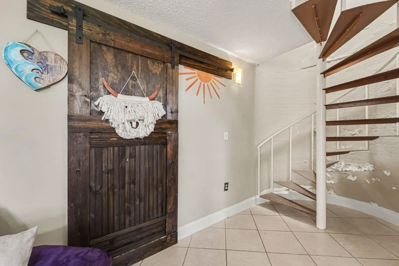 Open Concept Entry with Spiral Staircase &amp; Artistic Barn Door