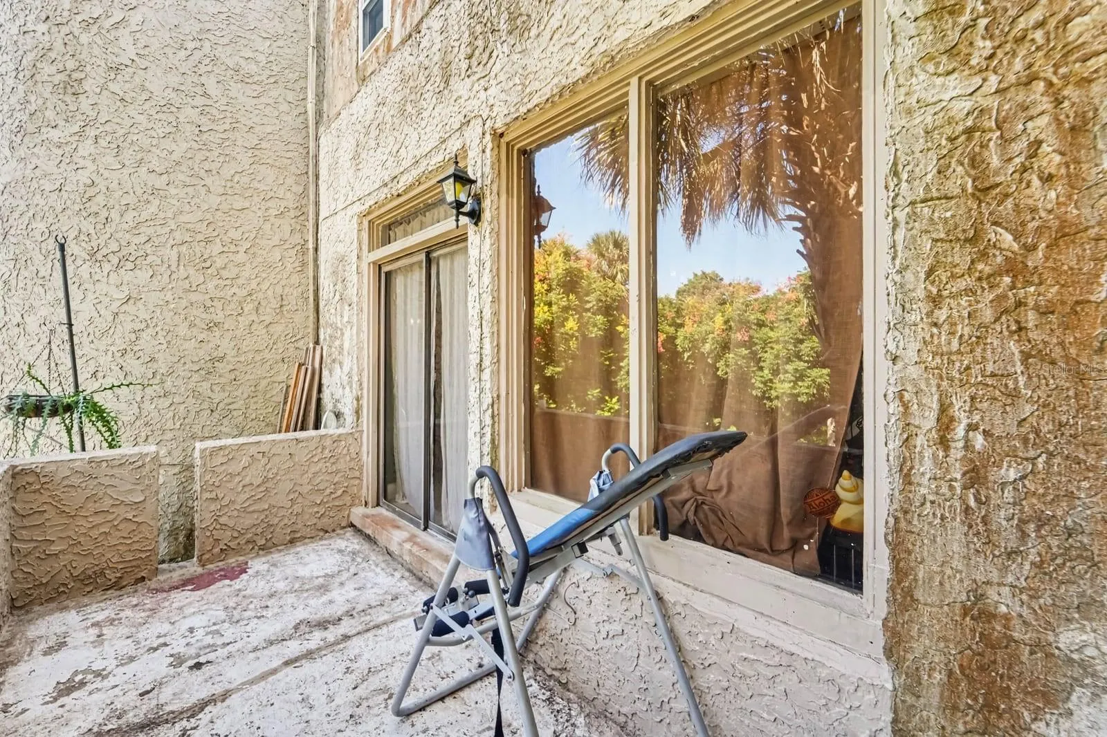 Rear Patio Access through Glass Doors Overlooking Lush Grounds