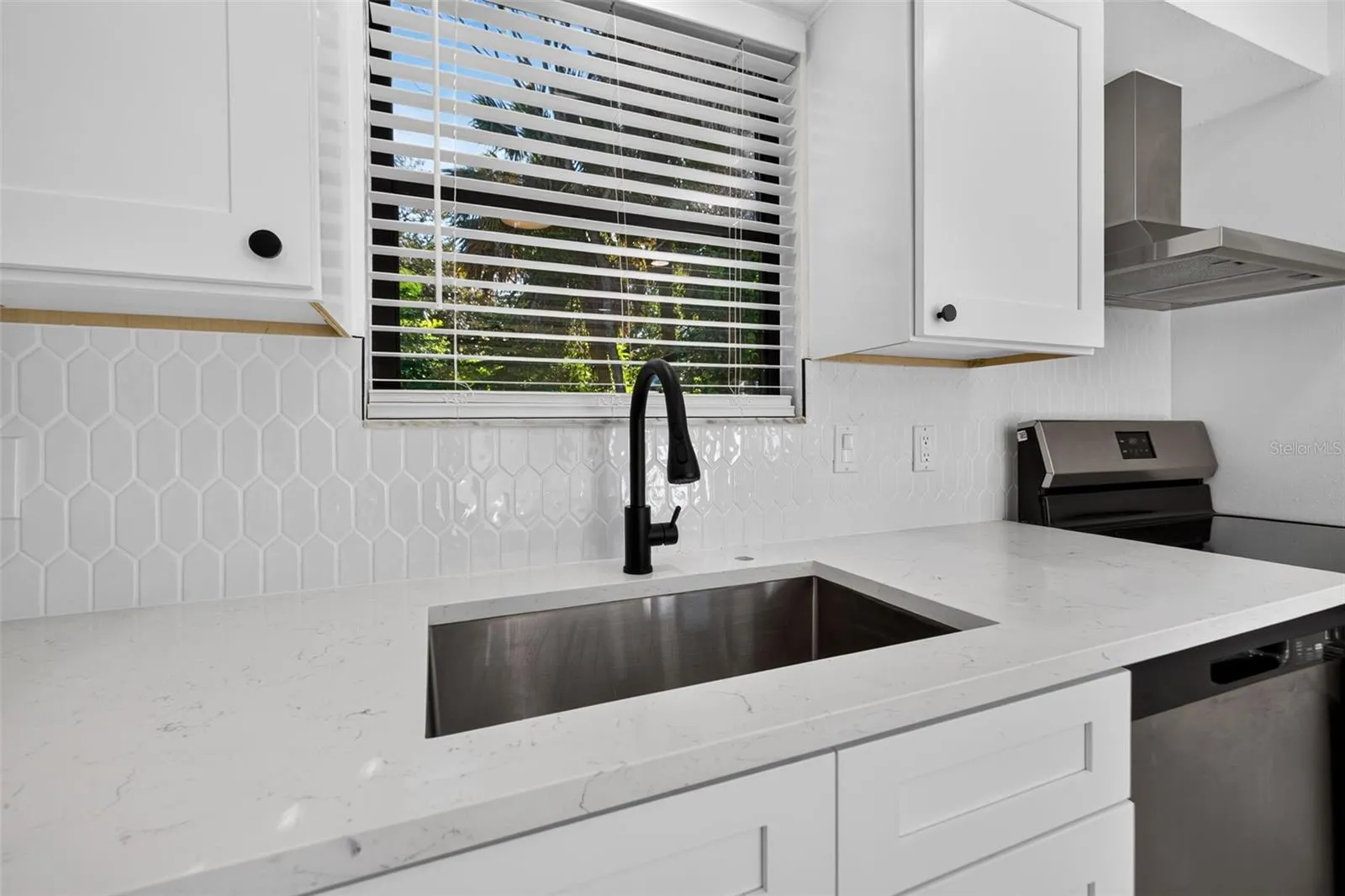 Bright white cabinetry, quartz countertops, and stylish finishes.