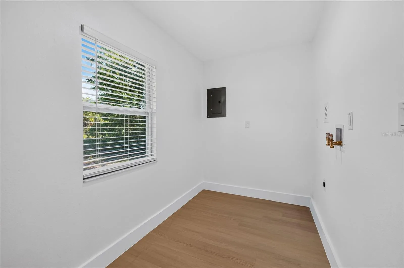 Convenient laundry room off the primary bedroom offers additional storage space.